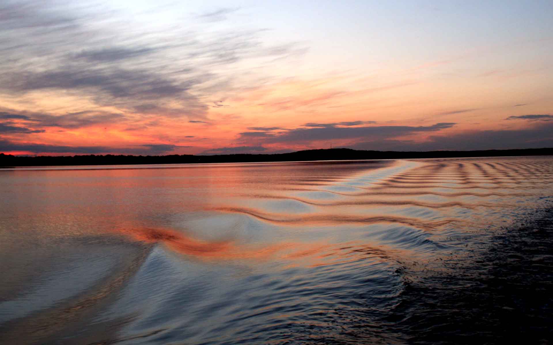 Boat waves on water at sunset on Lake Mille Lacs