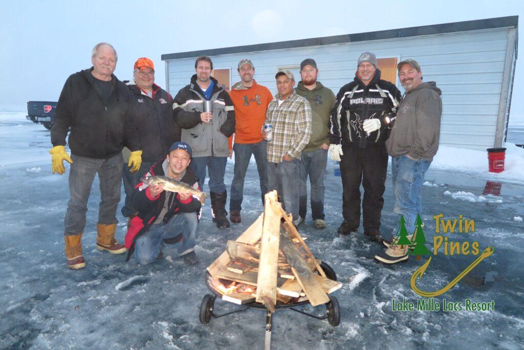group of men around a bonfire on a frozen lake
